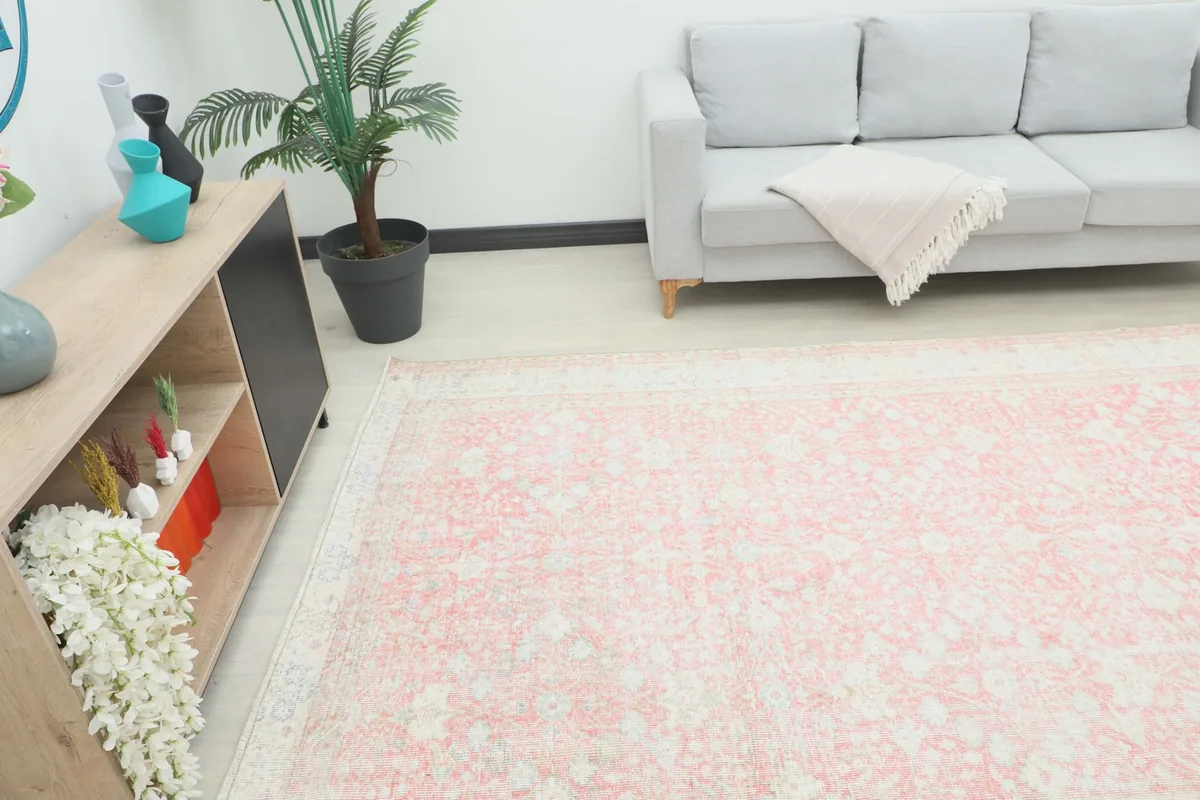Angle view of the rose floral rug in a room, showing its placement relative to furniture.
