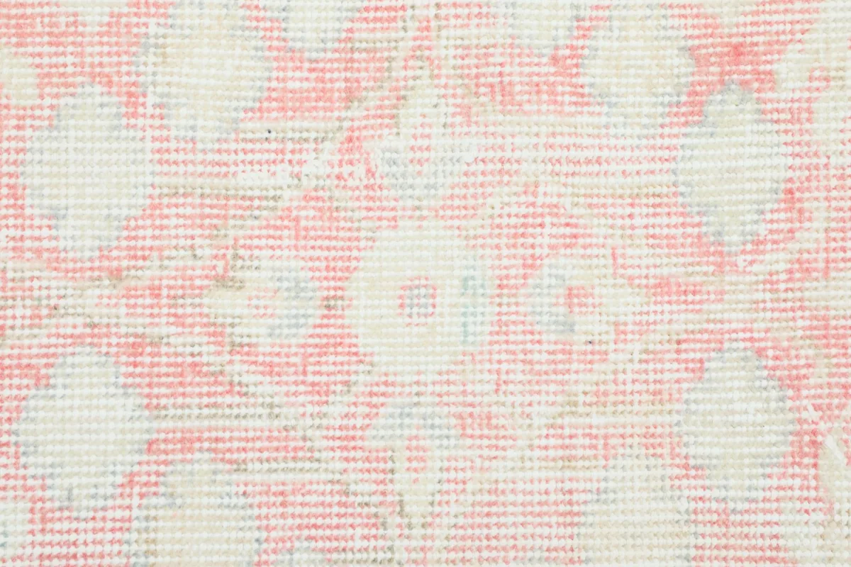 Close-up showing the low pile texture and the hand-knotted wool on cotton foundation.