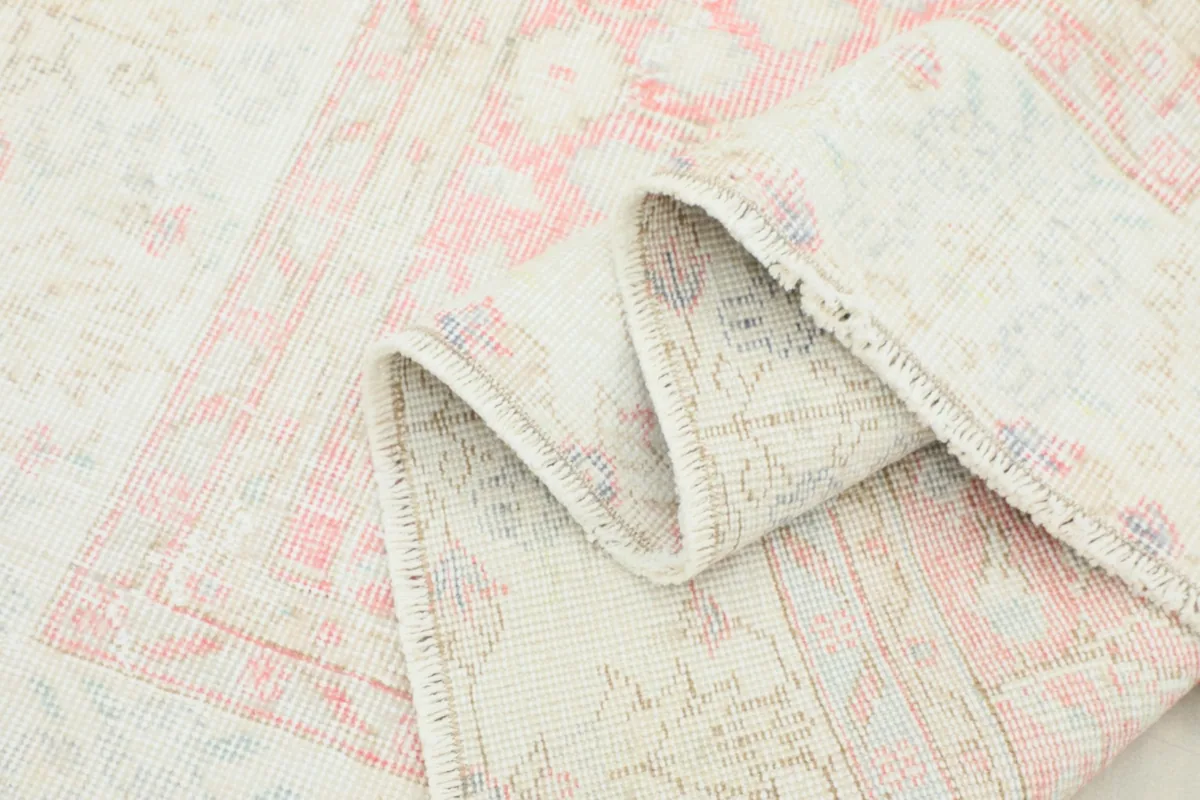 Folded section of the rug, illustrating its flexibility and the tight hand-knotted construction.