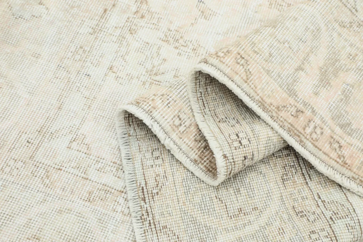 View of the rug folded, showing the thickness of the hand-knotted wool and cotton construction.
