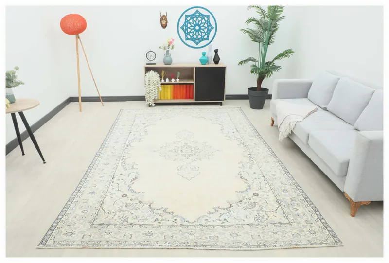 Full overhead view of the 6'9" x 10'5" ivory area rug with a central medallion on a white background.