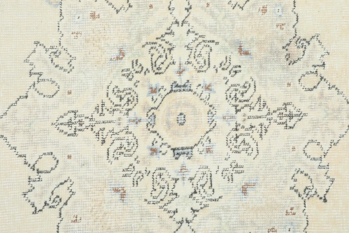 Close-up of the central medallion, highlighting the detailed floral patterns and slight wear.