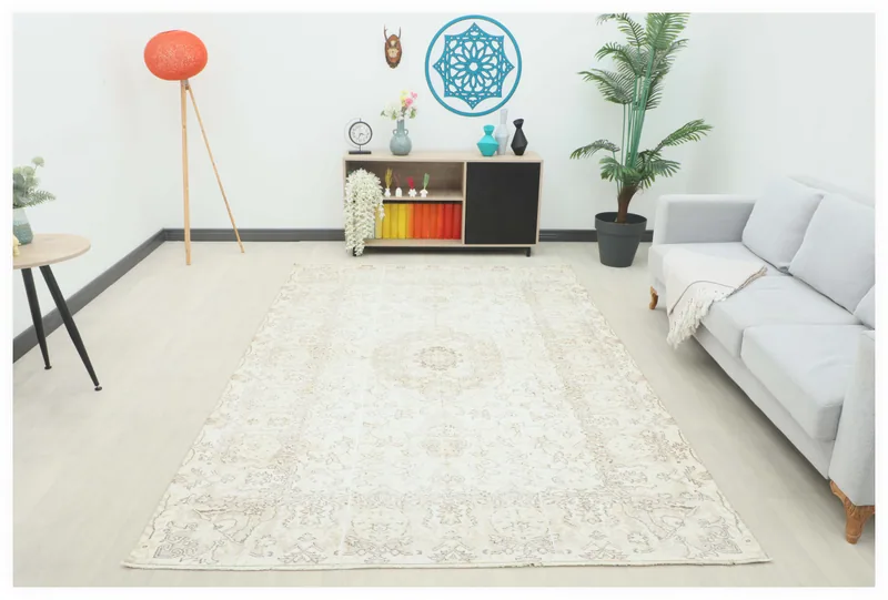 Full top view of the 6'5" x 9'7" ivory and beige vintage Anatolian area rug on a white background.