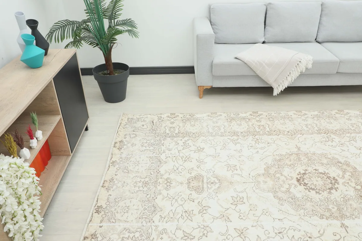 Overhead angle of the vintage rug in a living room, showing its placement relative to furniture.