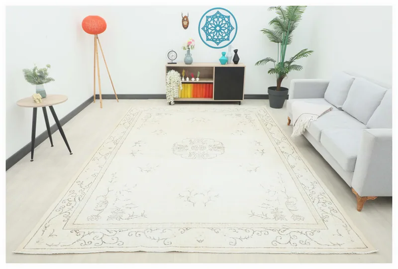 Full top view of the 8x13 cream vintage Anatolian area rug with a central medallion on a white background
