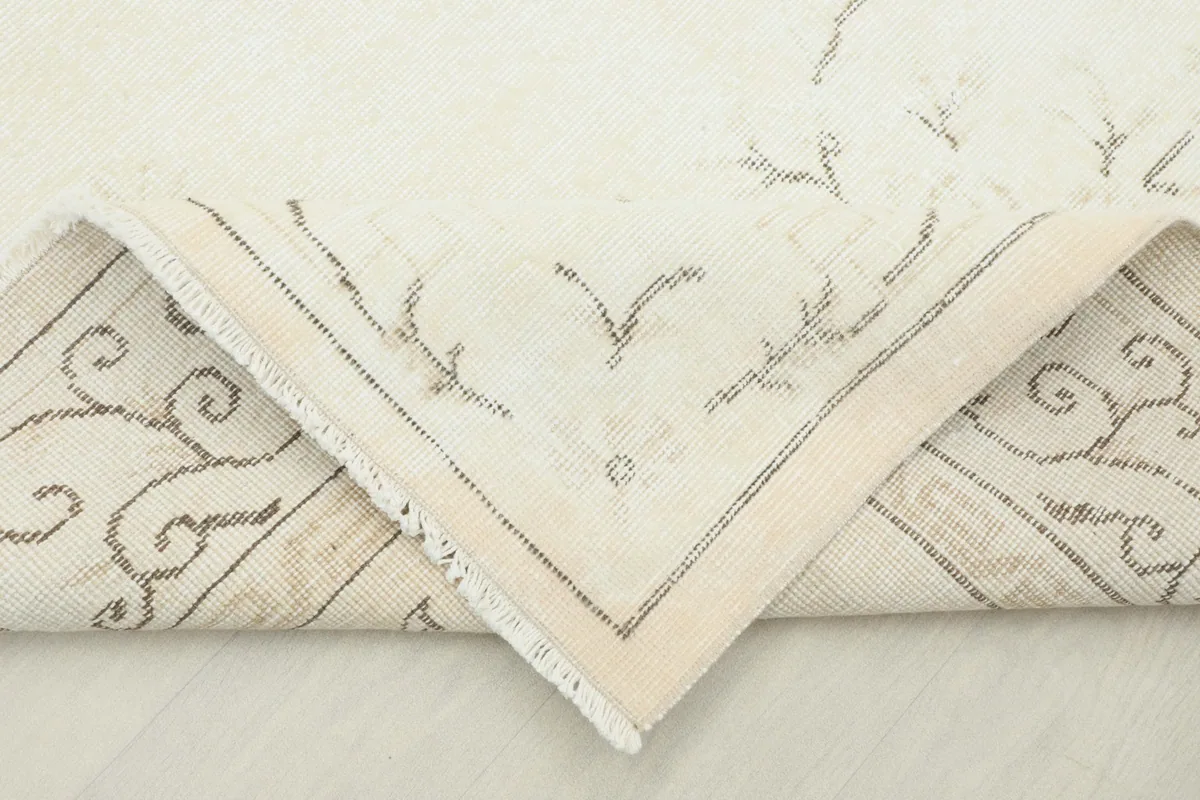 View of the back of the rug, showing the cotton foundation and hand-knotted construction