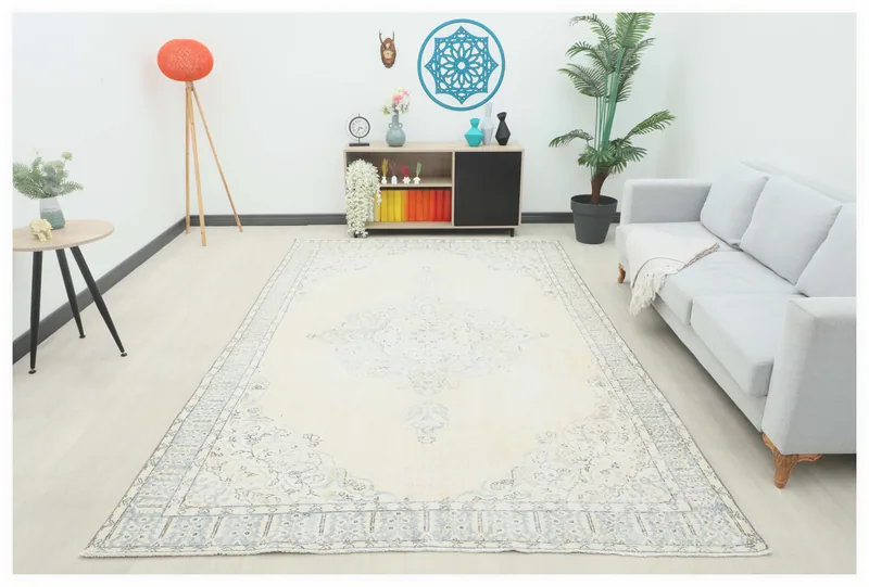 Full top view of the 6'10" x 10'8" ivory vintage Anatolian area rug with blue and gray patterns