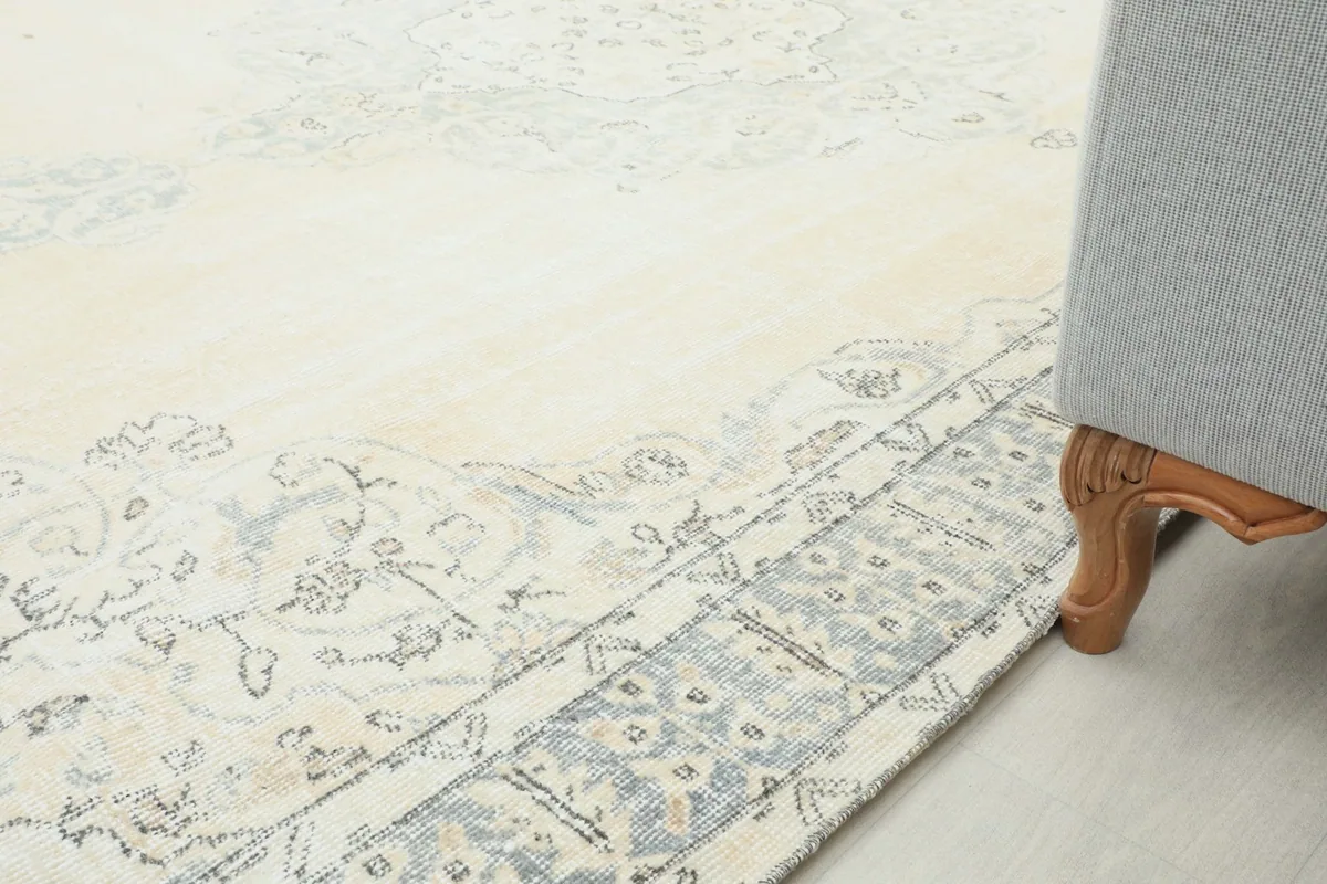 Rug placed under furniture, showing how the border interacts with a sofa leg
