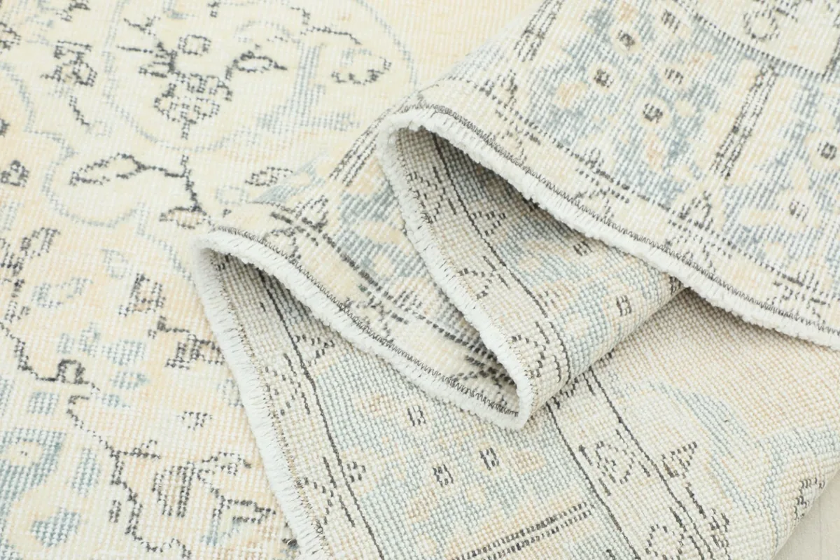 Close-up of the low pile texture and the tightly woven knots of the vintage Anatolian rug