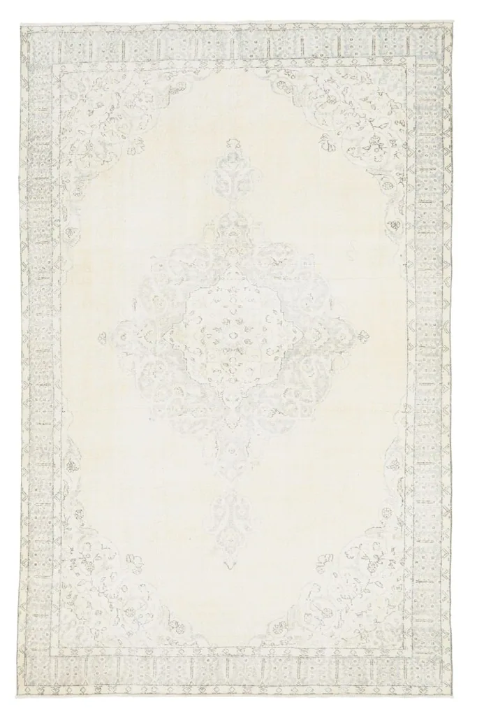 Full overhead view of the ivory vintage rug, emphasizing its entire pattern and shape