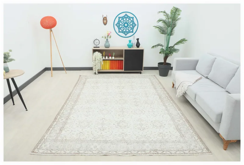 Full top view of the 6'8" x 9'7" ivory beige vintage Anatolian rug on a white background.