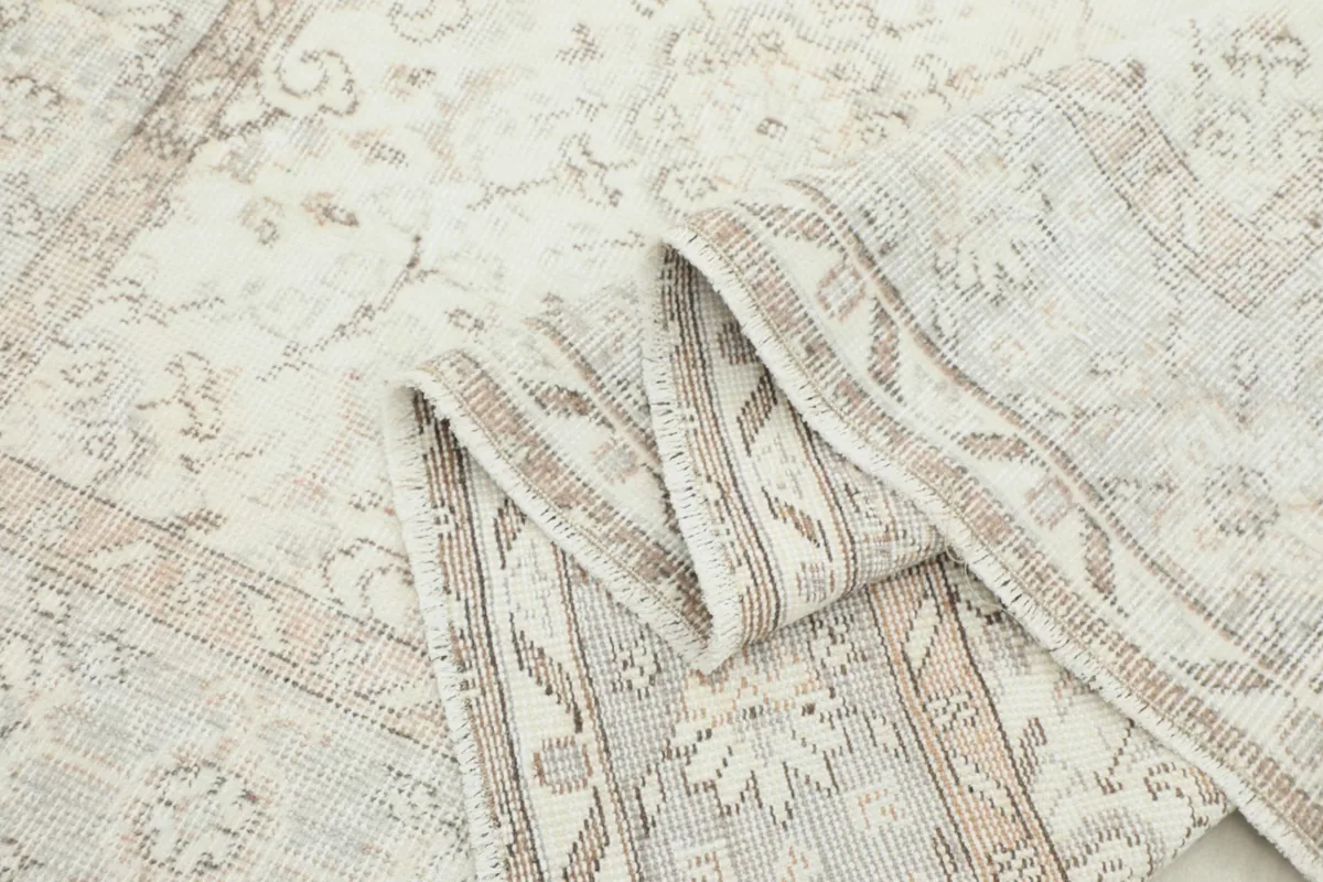 Folded section of the rug, showing the flexibility and texture of the hand-knotted wool pile.