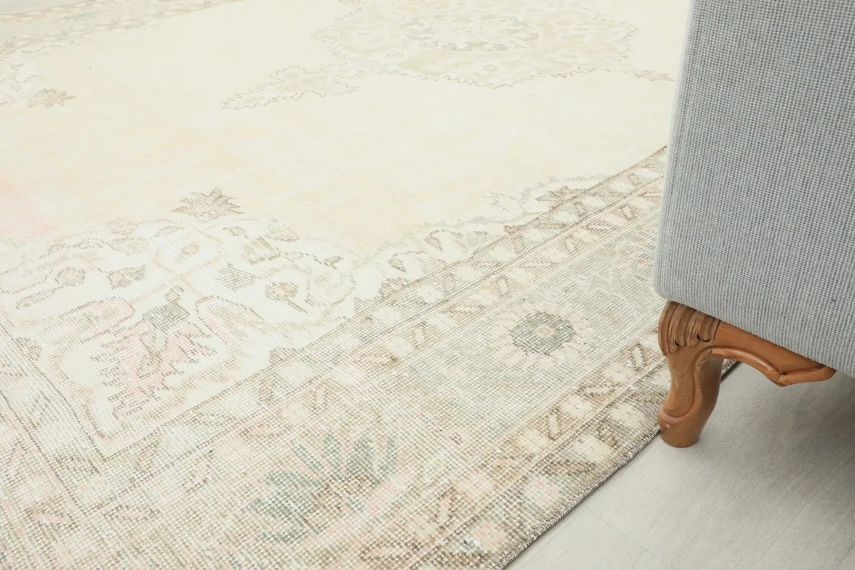 Rug placed next to a sofa leg, showing how it fits into a room setting