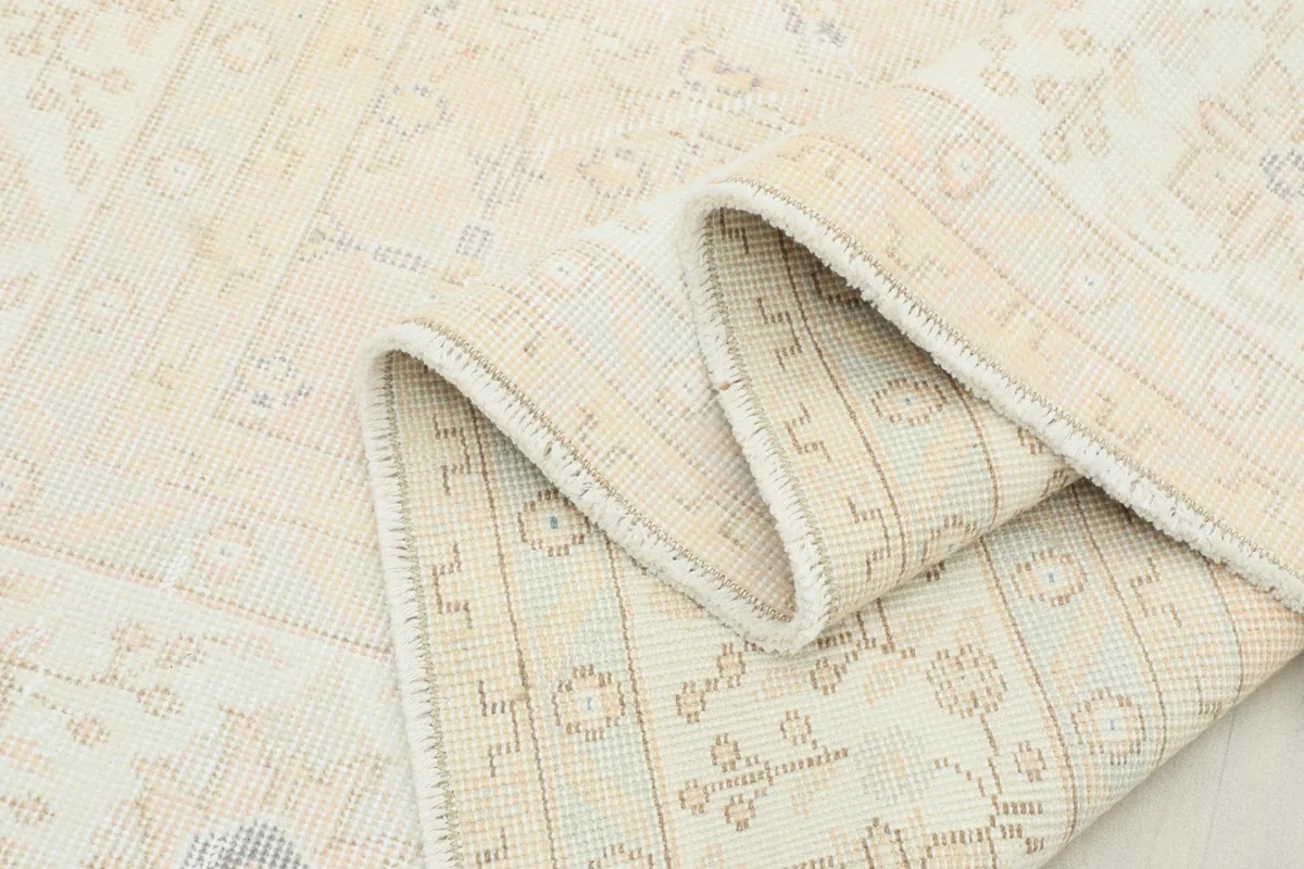 Multiple folds of the rug showing its flexibility and the consistent pattern on the reverse side