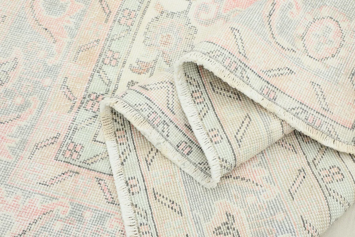 Folded section of the rug, revealing the detailed knotting and subtle color variations on the back