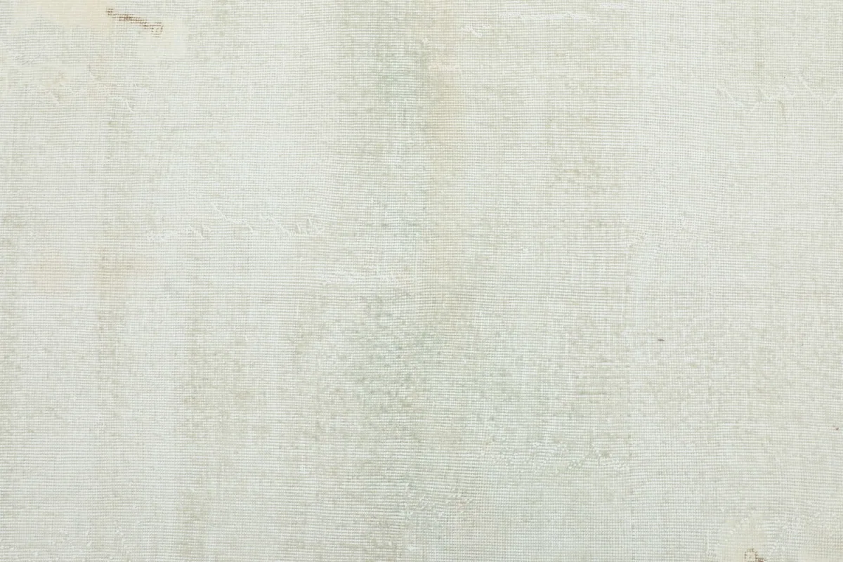 Detailed texture of the low wool pile in beige, showing subtle variations in color.