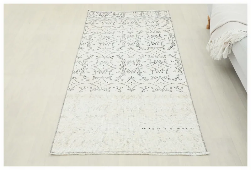 Full top view of the 2'11" x 6'3" vintage Anatolian runner with ivory field and charcoal patterns.
