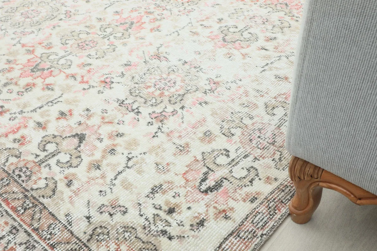Section of the rug next to a chair leg, illustrating its texture and how it complements home decor.