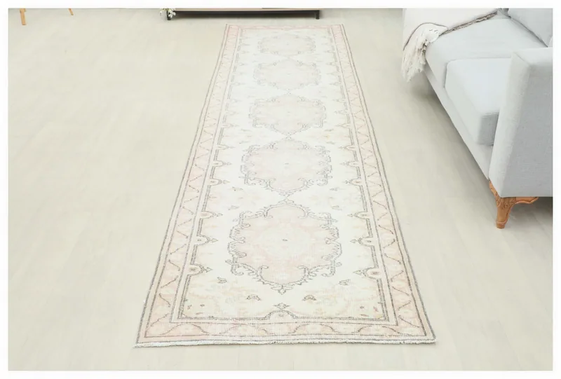 Full overhead view of the 3'1" x 11'5" ivory and rose vintage Anatolian runner rug