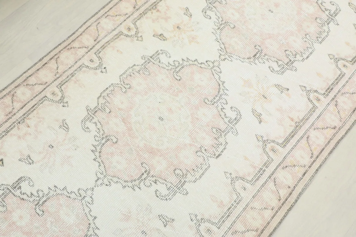 Close-up of the hand-knotted wool pile and medallion design on the runner