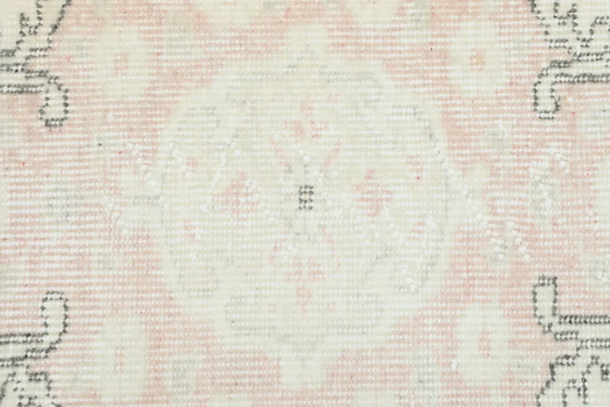 Texture of the low wool pile, showing the hand-knotted construction and slight wear