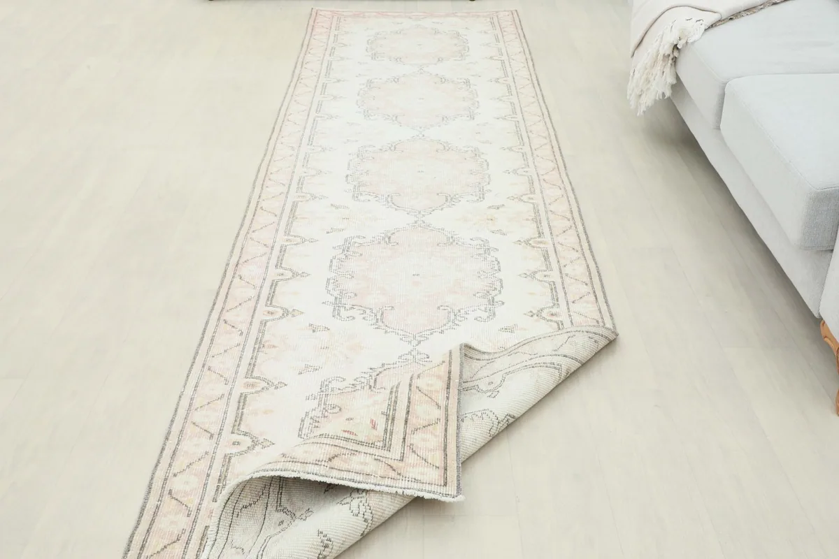 Partially folded runner rug, highlighting its flexibility and construction