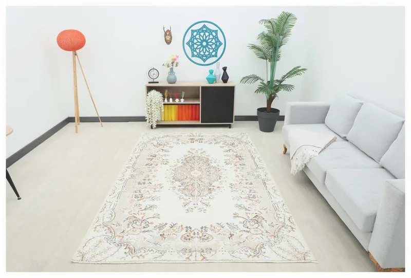 Full top view of the 5'6" x 8'7" cream and beige floral vintage Anatolian rug