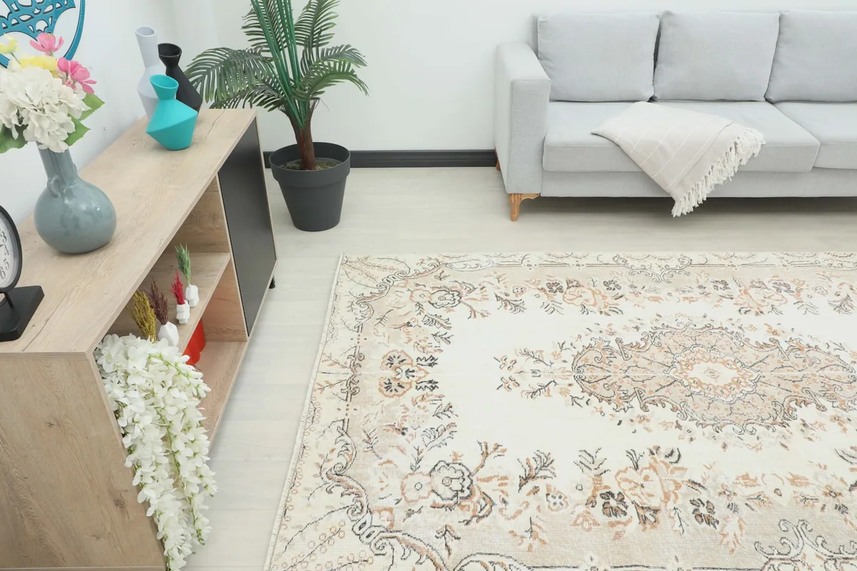 Angle view of the cream and beige rug in a room, showing its placement relative to furniture