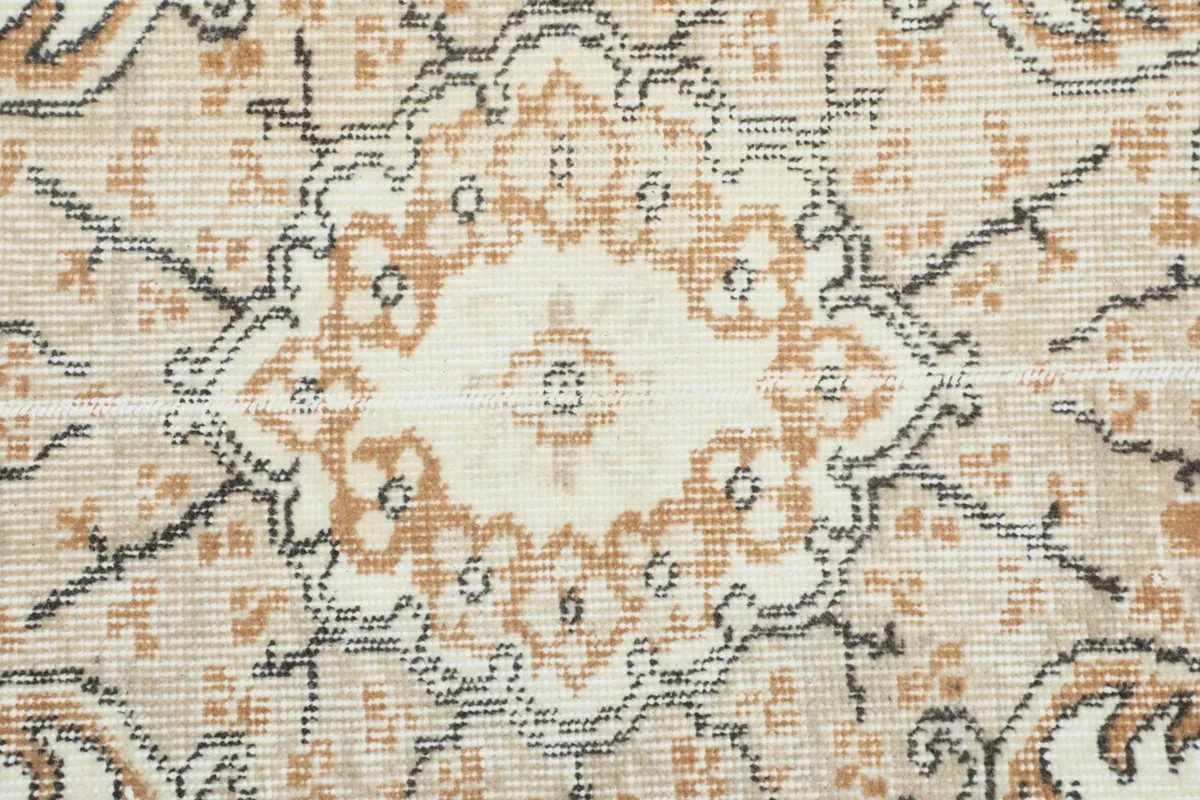 Close-up of the intricate floral and geometric patterns within the rug's design