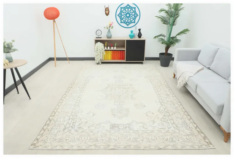 Full top view of the 7x10 ivory floral medallion vintage Anatolian rug on a white background.