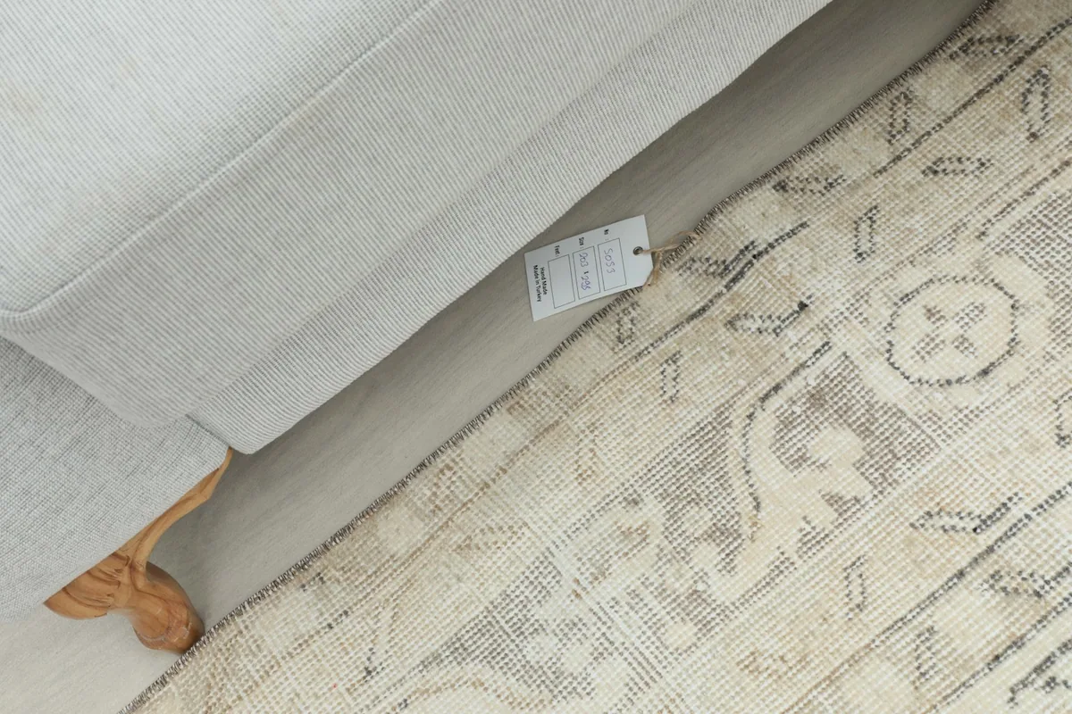Overhead view of the rug's edge and a small tag, demonstrating the rug's quality and finish.