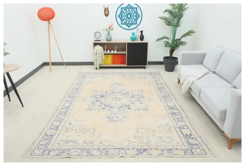 Full top view of the 6'8" x 9'8" beige and blue vintage Anatolian rug on a white background.