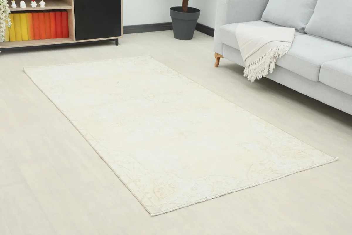 Angle view of the cream beige rug in a contemporary room, showing its full length