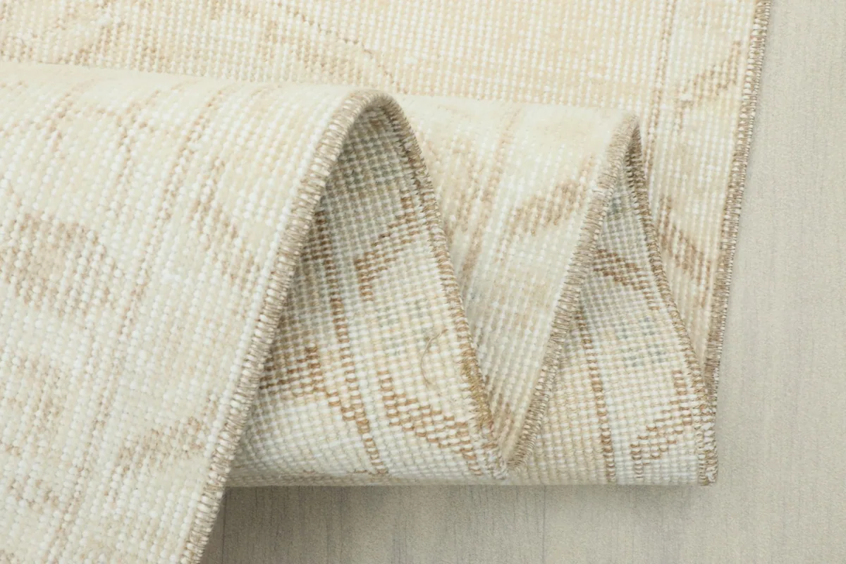 Close-up of the rug's fold, revealing the intricate weaving and foundation