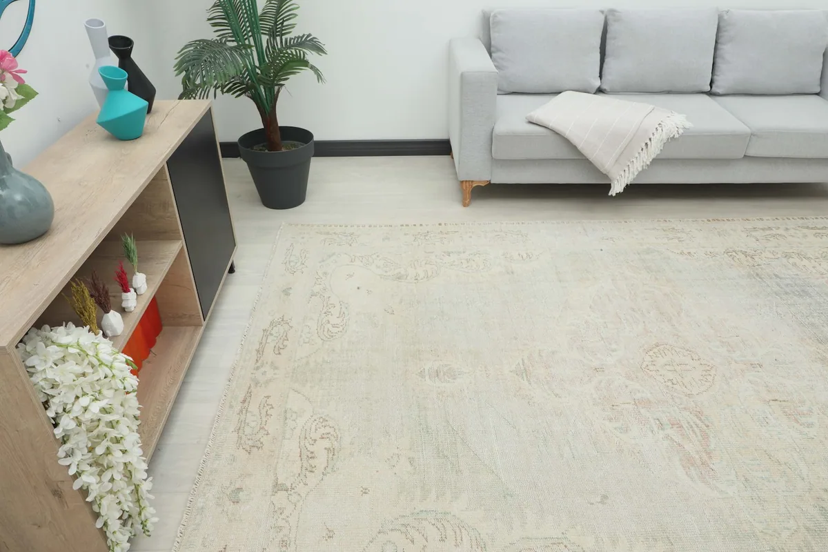 Angle view of the beige area rug in a room, showing its overall size and how it complements the decor