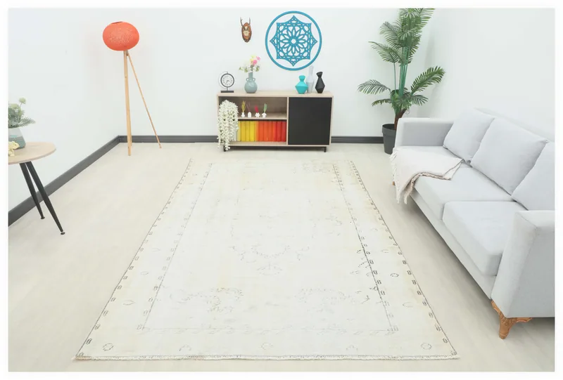 Full top view of the 6'1" x 9'6" ivory vintage Anatolian area rug with subtle medallion pattern