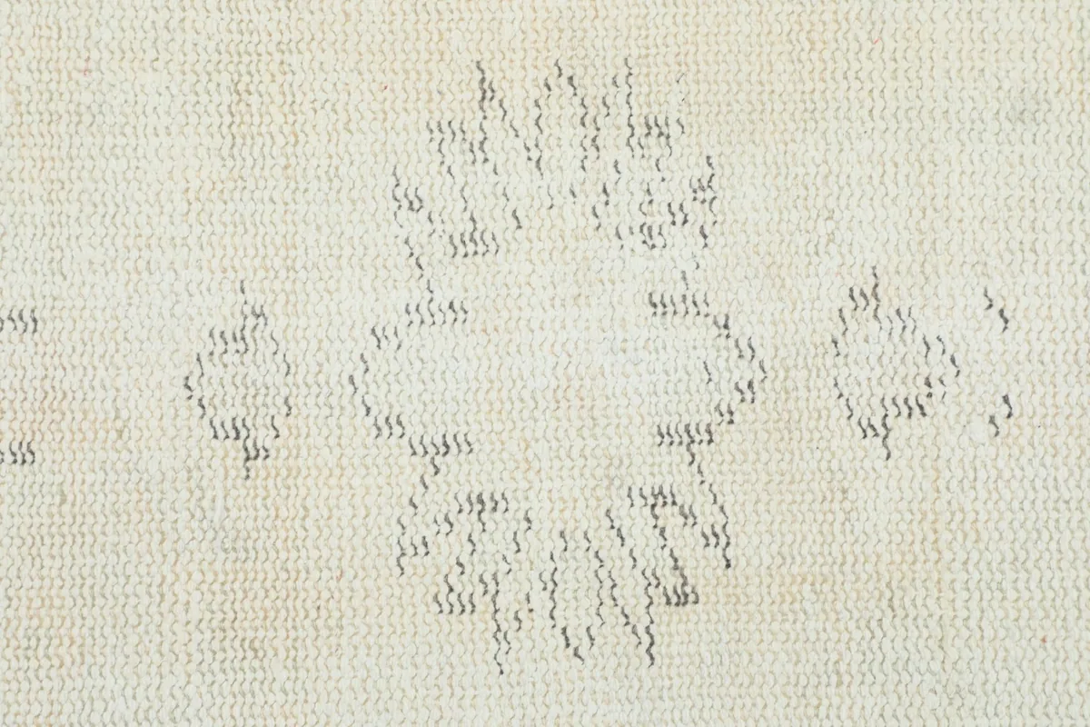 Close-up of the back of the rug, showing the hand-knotted wool pile on cotton foundation
