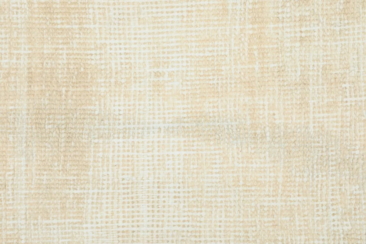 Detailed view of the rug's low pile and hand-knotted texture, showing the wool fibers.