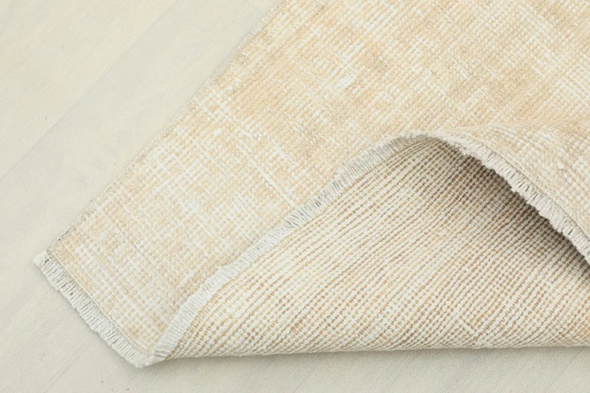View of the back of the rug, showing the cotton foundation and fine hand-knotting.