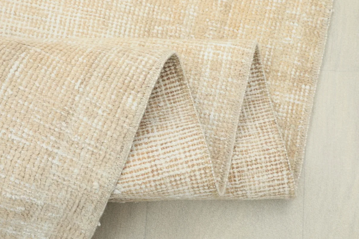 Close-up of the rug folded, showcasing the thickness and construction of the vintage wool runner.