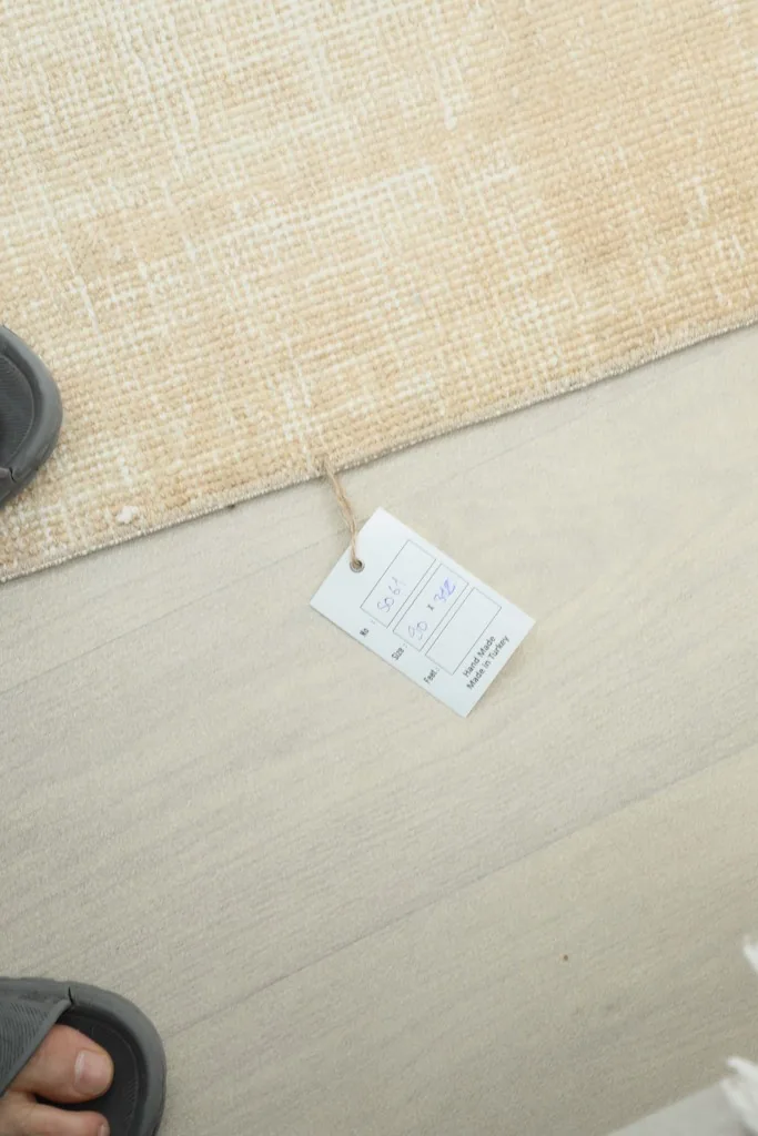 A small tag attached to the rug's corner, indicating its origin and material.