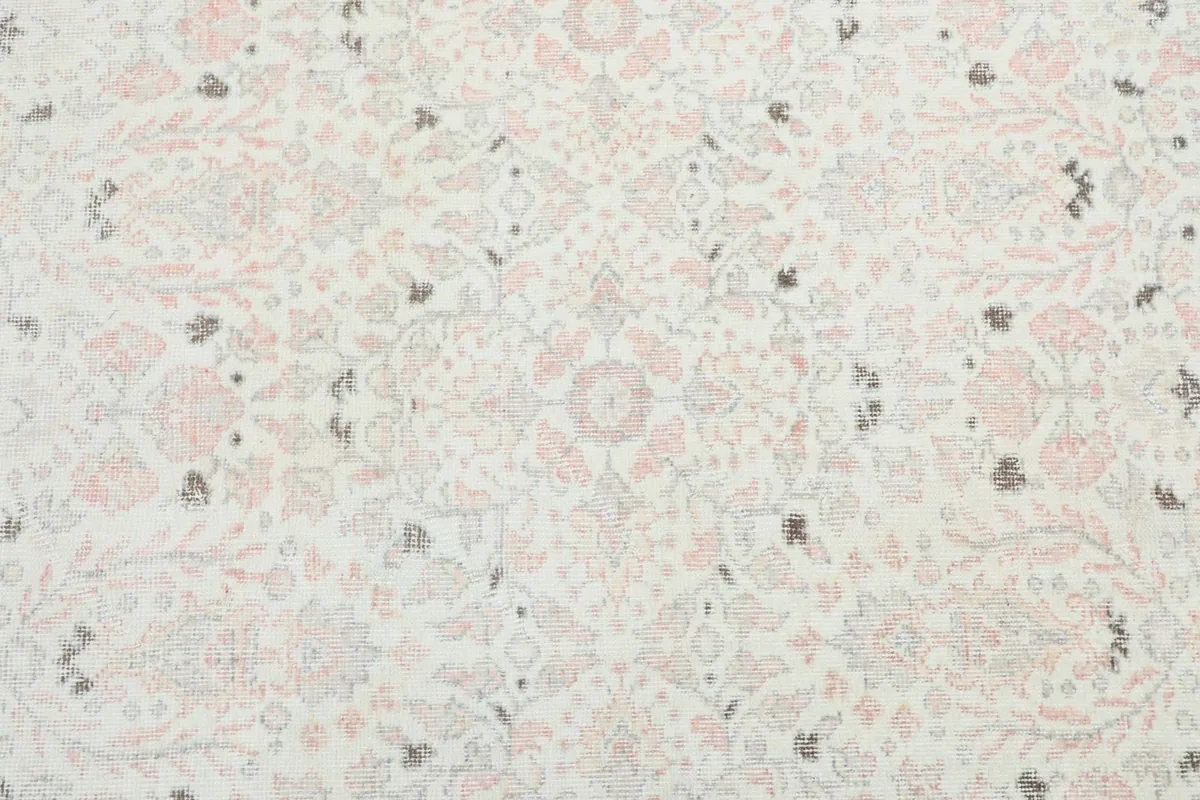 Detailed overhead view of the rug's central field with a subtle floral and medallion motif.