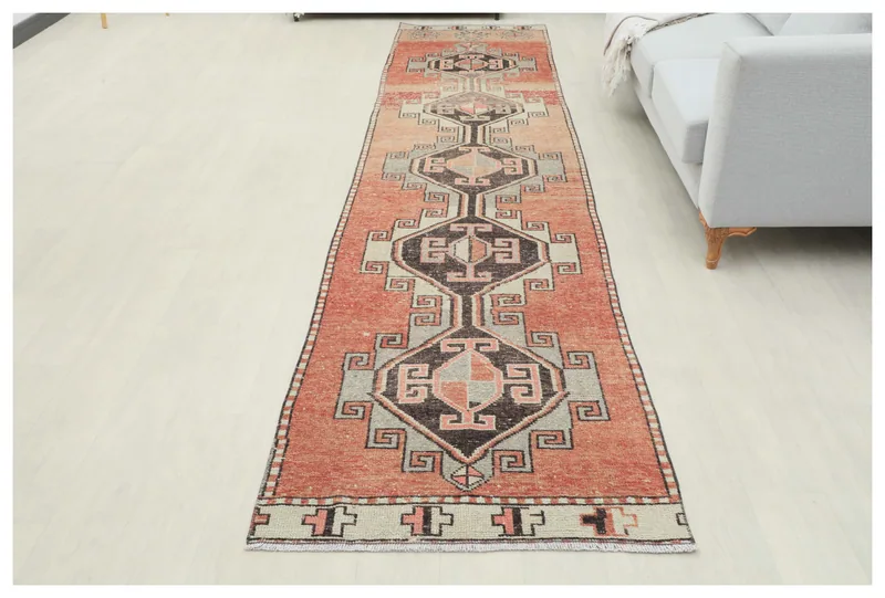 Full top view of the 3x13 vintage Anatolian runner rug with rust and gray geometric patterns