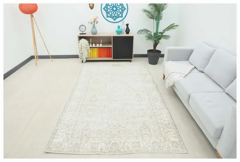 Full top view of the ivory and beige vintage Anatolian area rug on a white background