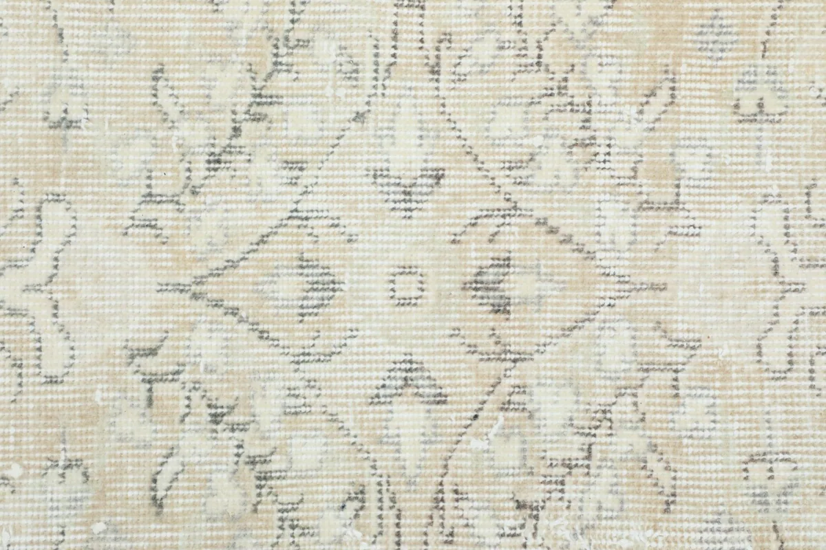 Tight detail of the central medallion and geometric elements in the rug's design