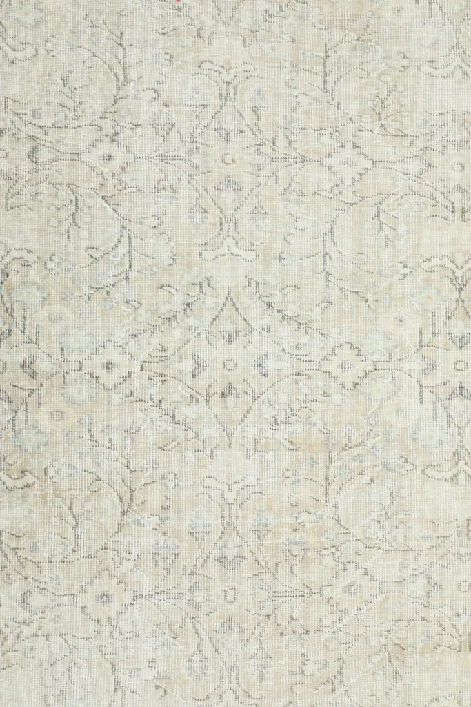 Overhead view showcasing the full pattern of the ivory and beige vintage rug