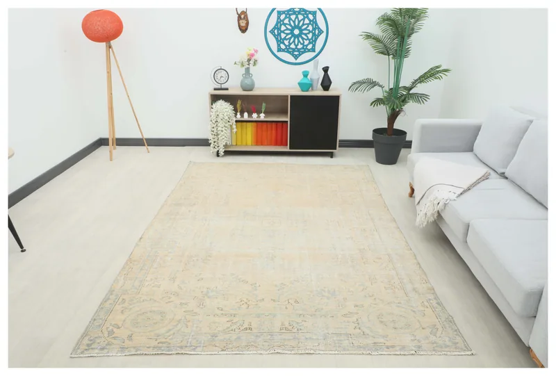 Full top view of the 6'1" x 8'8" beige and blue vintage Anatolian rug on a white background