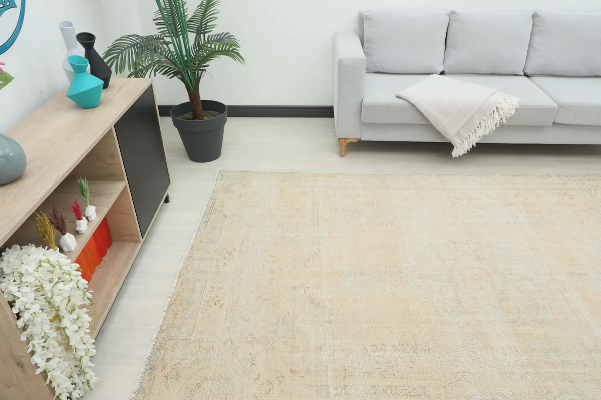 Wide shot of the rug in a room with a light gray sofa and modern decor, showing its full size