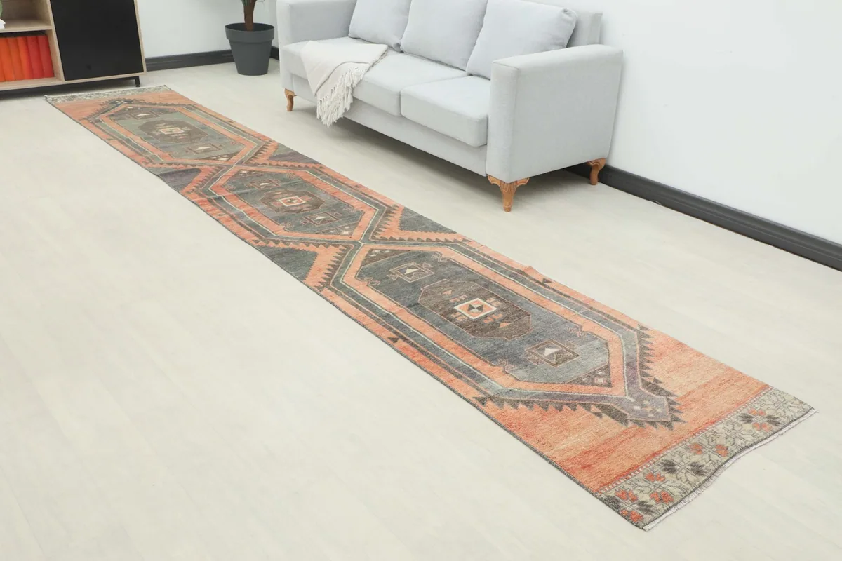 Long view of the hand-knotted runner rug in a room, highlighting its length and design