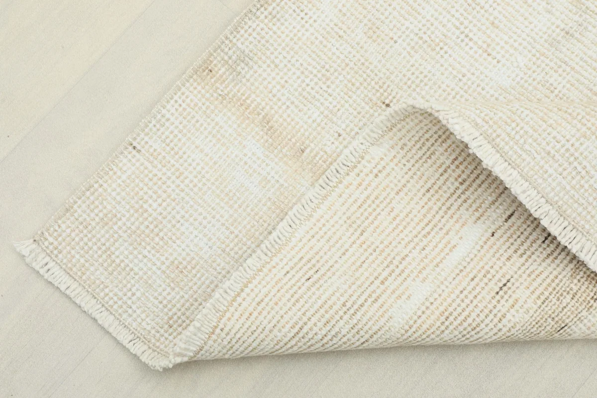 View of the back of the rug, showing the cotton foundation and tight hand-knotting.